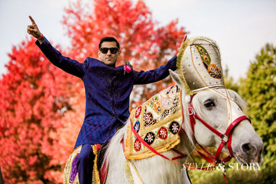 Indian Groom riding a horse during the baraat.