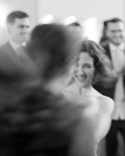 Blurry photograph of the bride dancing with one of her friends on the dance floor