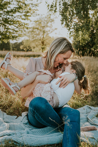 Mother playing and laughing with child outdoors