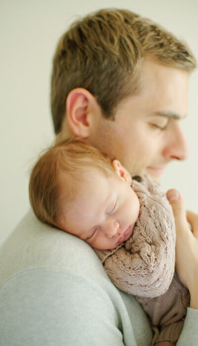 Baby sleeps on dad's shoulder, captured by Tevi Hardy, san francisco