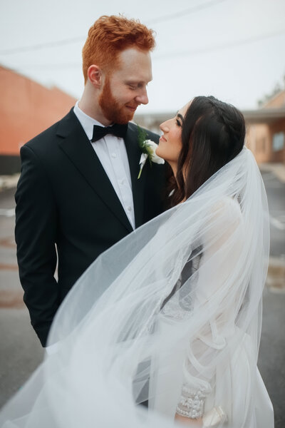 Groom kissing the bride’s forehead after their wedding 