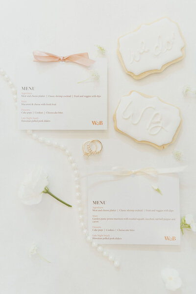 wedding flatlay with custom menu cards and florals