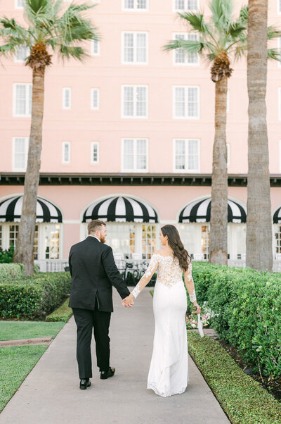 couple walking outside their grand galvez wedding