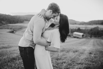 couple hugging at sunset beside water