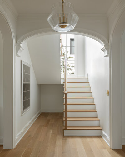 Bright white stairwell with archways