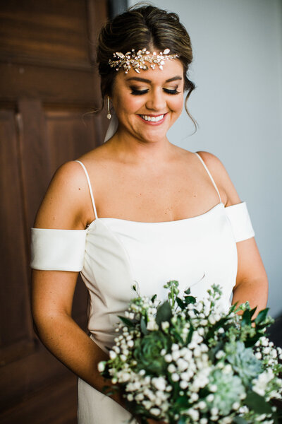 Bride holding bouquet with headpiece