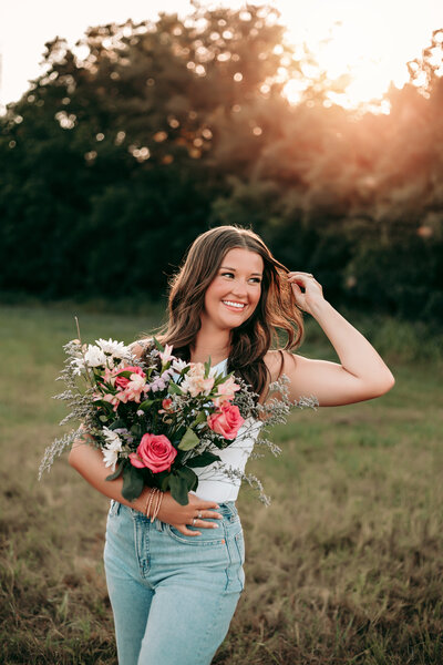 girl senior session at sunset with flowers