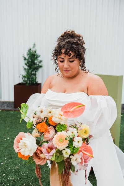 Bride with colorful bouquet at Mae's Ridge wedding planned by Bianca Nichole and Co