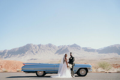 Bride and groom posing in front of a retro care at Valley On Fire