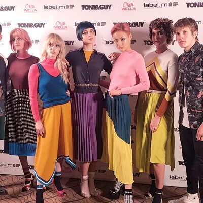 DJ and live music performance at Toni & Guy fashion launch with branded backdrop and models