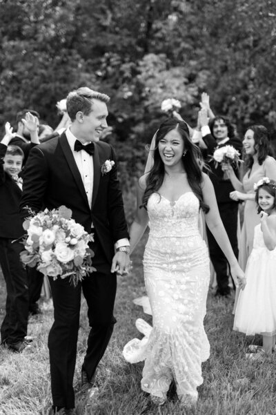 bride and groom embracing and walking together, taken to show minneapolis wedding photography