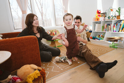 Baby takes first steps during an at-home family session in Nyack, New York