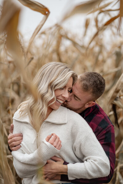 Couple playing in  a corn field during lifestyle photography in Ottawa