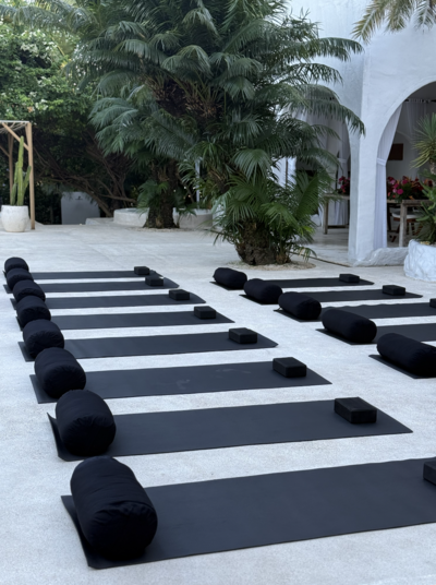 A group of women conversing in a yoga studio after doing yoga.
