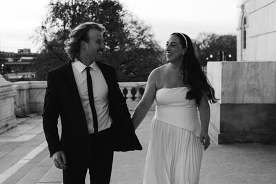 Bride and groom standing in front of beach house