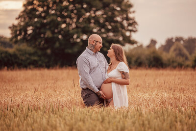 mother-and-son-posing-on-white-background-for-maternity-photoshoot