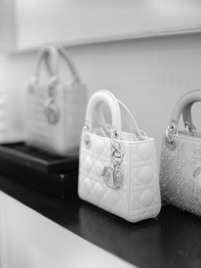 White and pink small handbags on a shelf