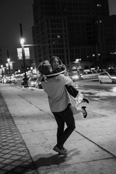 A person lifting up their partner in a hug