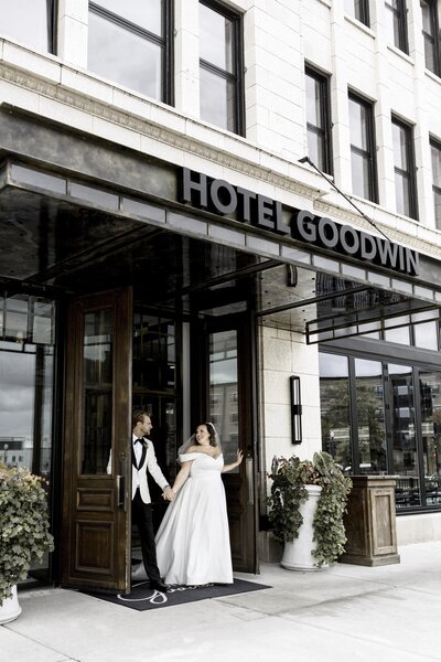 Bride and Groom exiting Hotel Goodwin on their wedding day