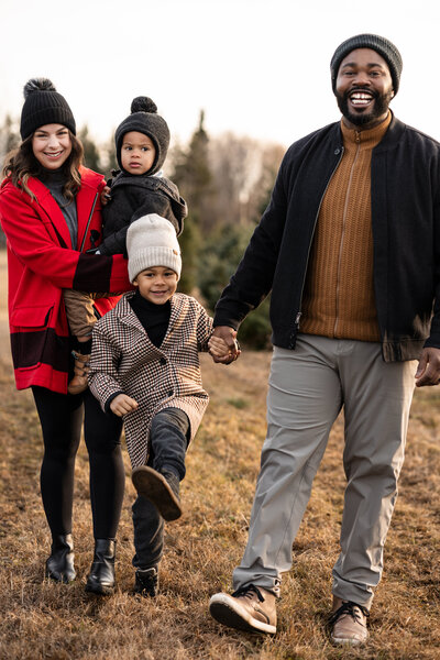Family of four walking at a tree farm in Ottawa