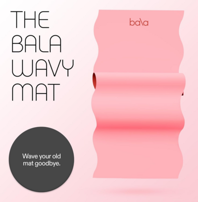 Pink Bala Wavy Mat on a neutral surface, designed for yoga and home workouts.