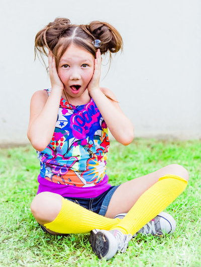 colorful and fun photo of a little girl with a surprised look on her face
