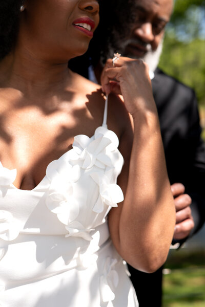 A person standing behind their partner and reaching for them 