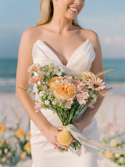 bride holding bouquet by wedding planner in Tampa