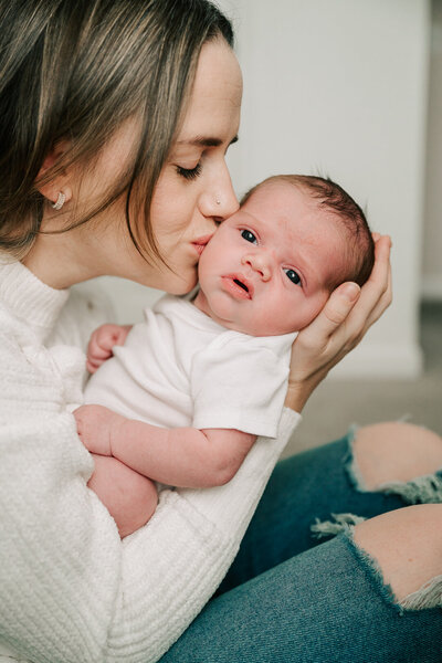 baby girl sleeps while parents laugh during their newborn session