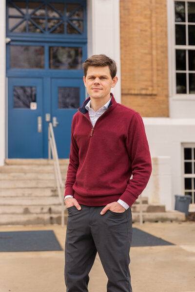 man standing hands in pockets in front of a public building in Atlanta GA Brand Photographer
