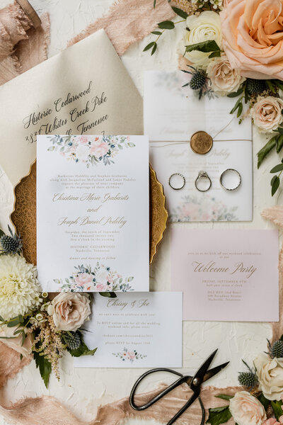 flat lay of wedding invitation and rings