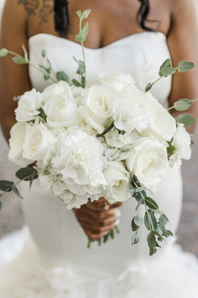 Bride holding an elegant, all white bouquet in front of her