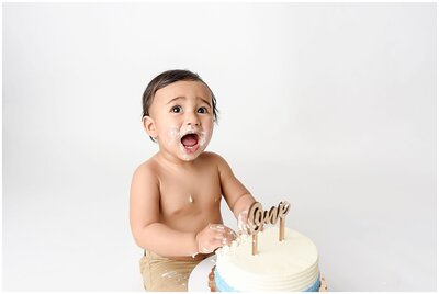 A delightful cake smash session capturing the messy and playful moments of a child's milesone.