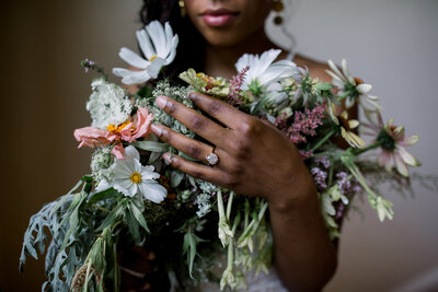A Bride holding a bouquet of locally grown flowers 