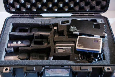 Photography lighting kit with Godox flashes and Lume Cube lights organized in a protective case, used by Joseph Mayden for dynamic lighting in portraits and events.