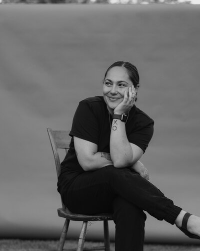 black and white photo of woman sitting on a chair