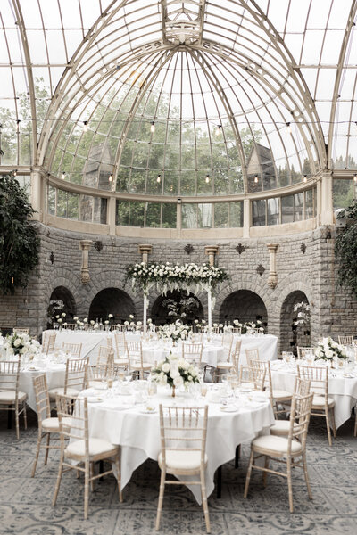 Tables dressed with flowers from Catherine Gray Florals in the Orangery at Tortworth Court