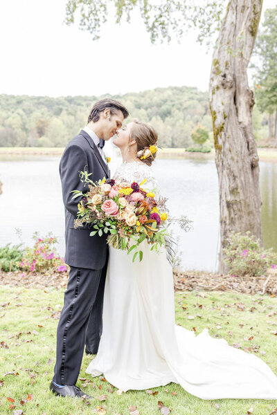 Colorful Ohio wedding portrait of bride and groom by lake