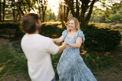 Couple spinning around during warm Nashville engagement session