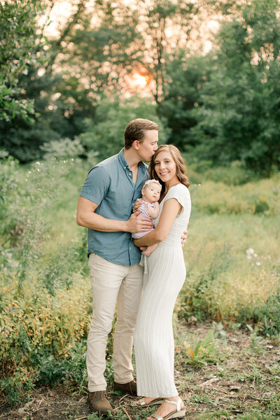 newborn photographer film baby girl held by mom in nursery lifestyle photography rochester minnesota