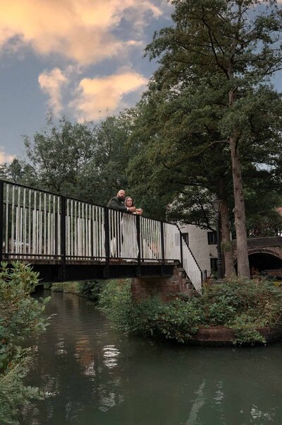 Bride and groom standing together on the canal bridge at Worsley Court, Manchester wedding photography