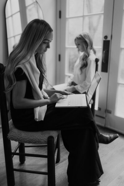 Black and white branding portrait of an interior designer working on a laptop in studio — Greenville SC branding photography by Dani Lacey Photographs.