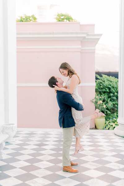 Couple kissing in front of The Pink Figgy in Historic Charleston