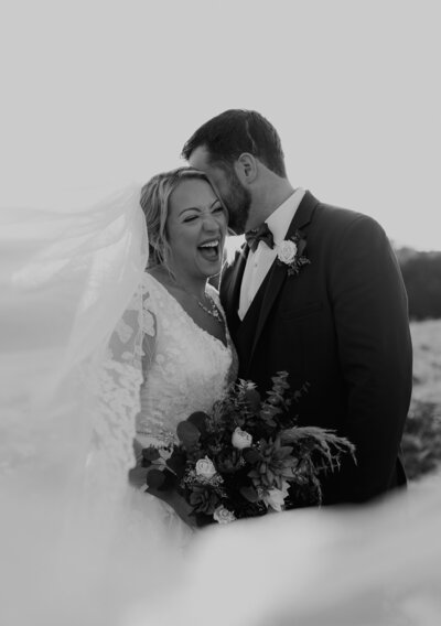 groom kissing brides cheek