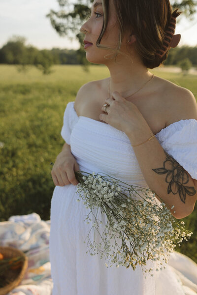 studio maternity session in kcmo made extra special with flowers and denim jeans with white bra. Studio window light made it look like film