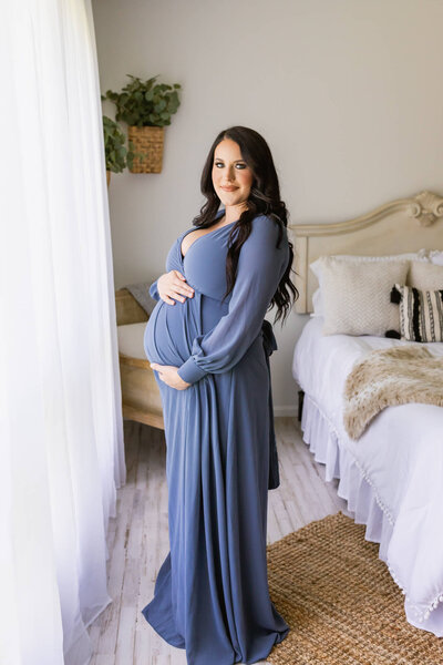 Expectant mom in a blue maternity dress