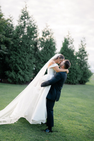 A bride and groom kissing after their Cape May wedding ceremony.