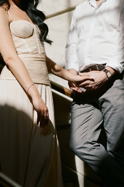 bride and groom holding hands in artful light 