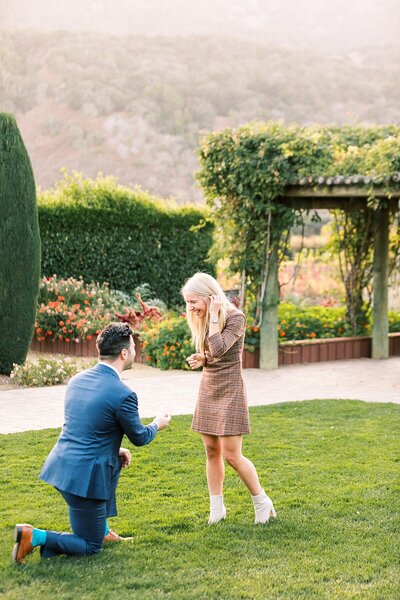 bride and groom signing ketubah holding hands together holman ranch wedding