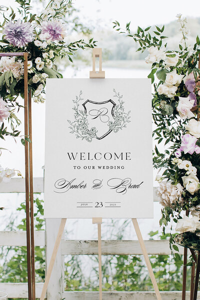 Floral crest wedding welcome sign for a purple and green outdoor summer wedding in Montana